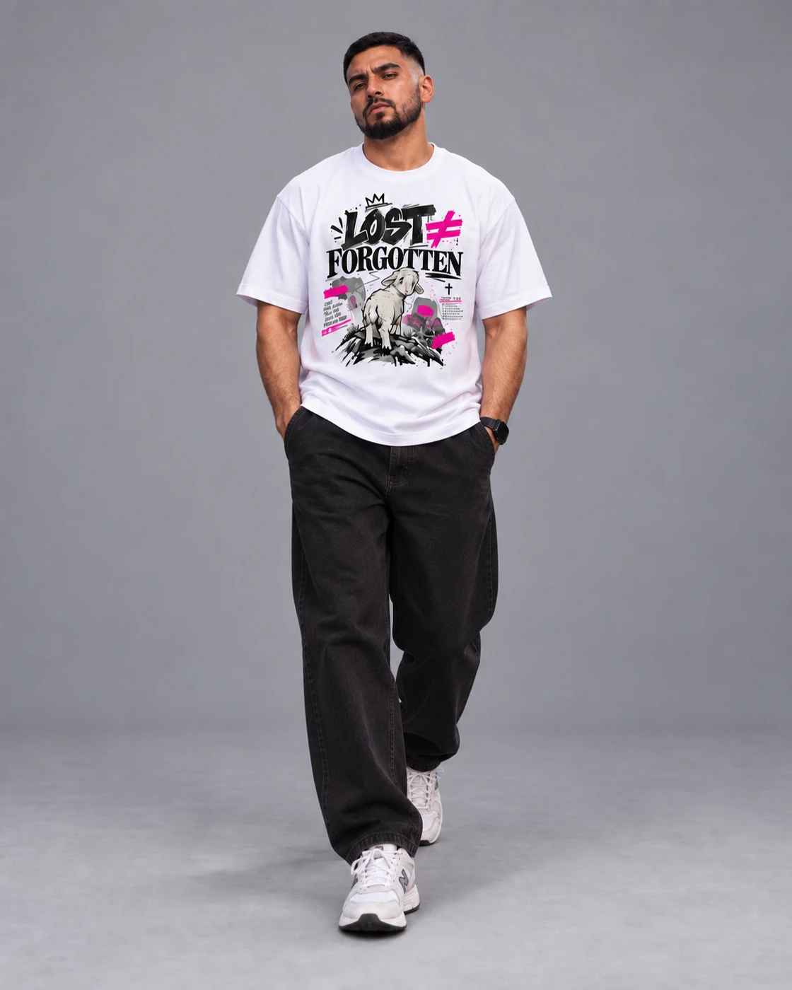 Juan in a white Lost ≠ Forgotten tee and dark trousers, seated in an urban setting